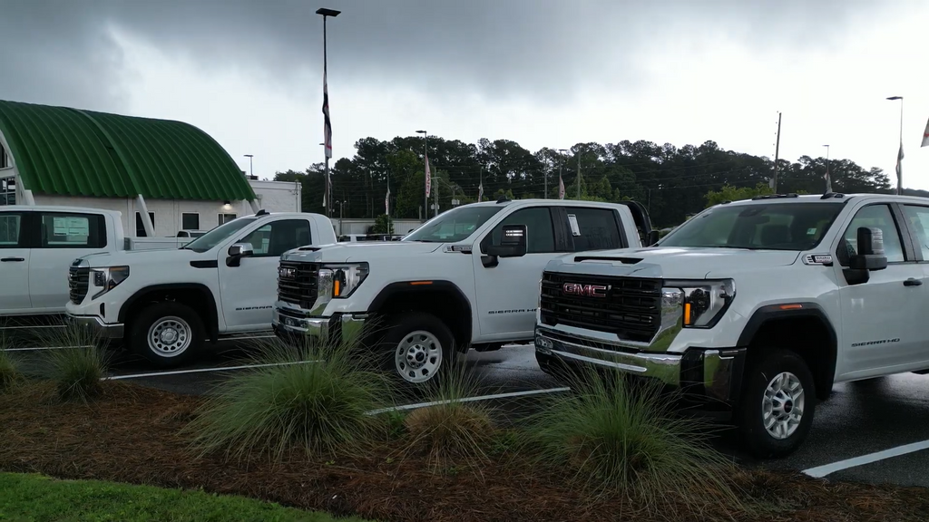 white pick up trucks lined next to each other for a picture 