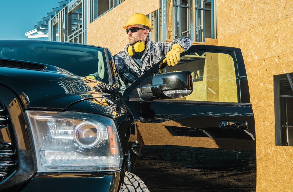 worker on the window of his truck looking to the horizon