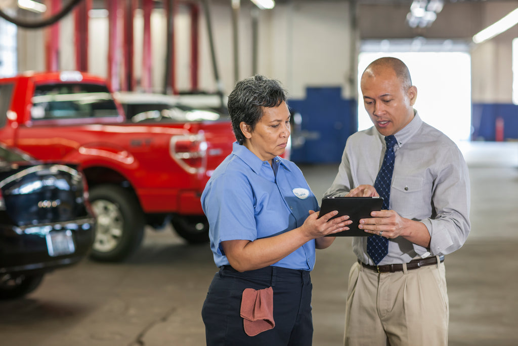 mechanic and sales man with a contract on hands